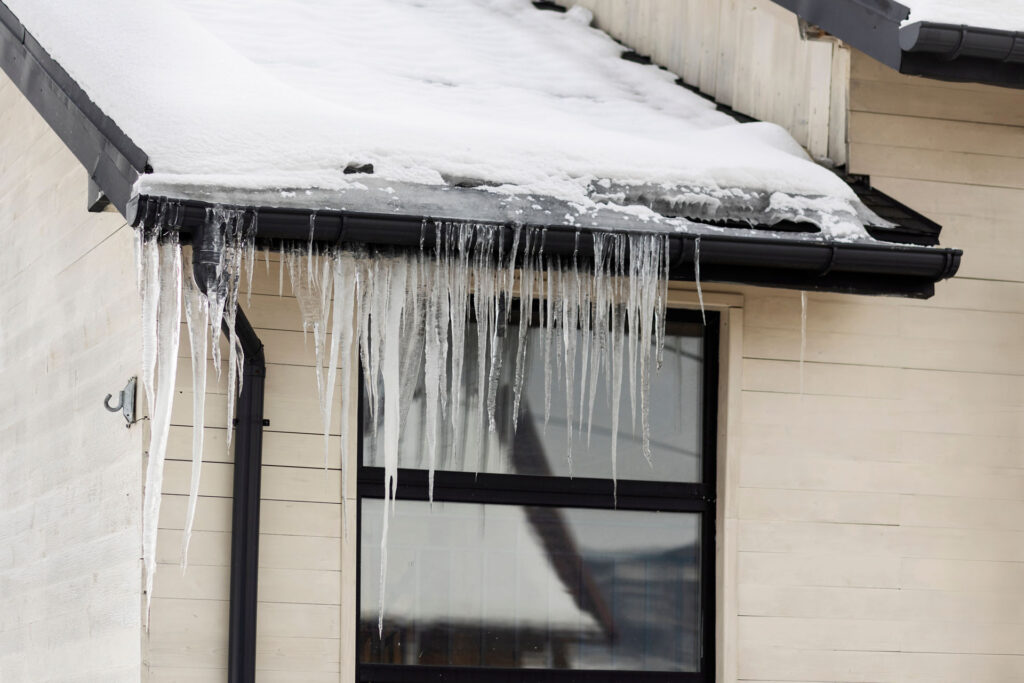 Ice dam forming along roof edge during winter conditions in Michigan
