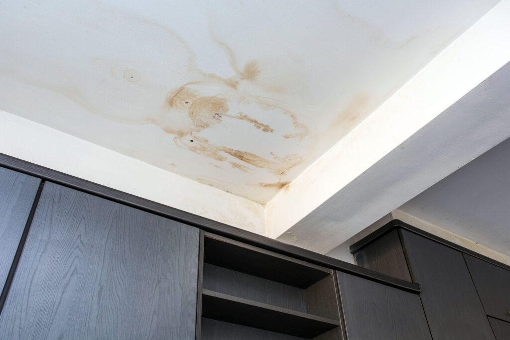 Water stain on interior ceiling caused by roof leak damage